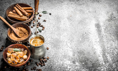 Coffee background. Coffee in turkey with crystals of sugar, cinnamon and ground coffee.