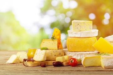 Tasty beautiful cheese composition on wooden board