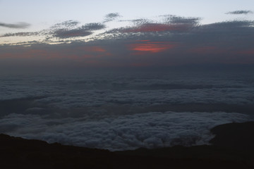 Cloud inversion in mountains during dawn before sunrise