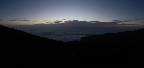 Cloud inversion in mountains during dawn before sunrise