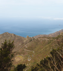 Fototapeta na wymiar Remote road on through the hills next to the ocean