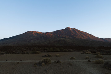 Fototapeta na wymiar Sunrise light on volcano in desert landscape