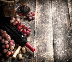 Wine background. Red wine with glasses with grapes.