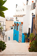 Very narrow street in small town in Spain .Urban cityscape. Mediterranean village.