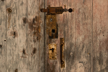 An old wooden door with a rusty bolt.