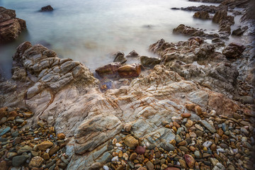 Sea wave impact with rock streak like a boil water with clear sky, Khao Leam Ya National Park at Rayong of Thailand (Long Exposure Technique photograph)