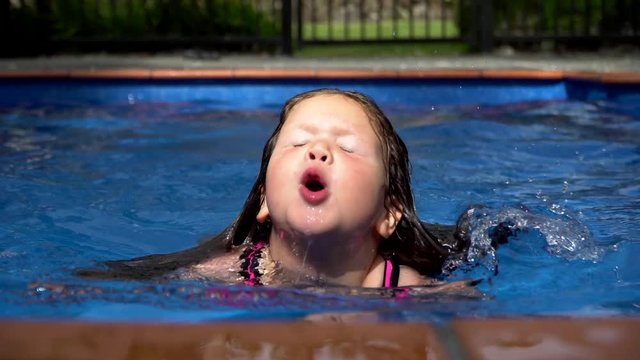 Young Girl Learning to Swim Across Swimming Pool 4K