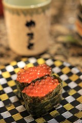 A Shallow depth of field shooting of Salmon eggs roll with sea weed sushi.