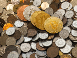 Bitcoin coins on large stack of coins