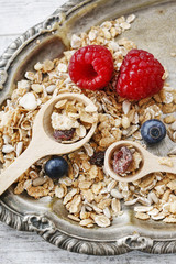 Two wooden spoons with muesli.