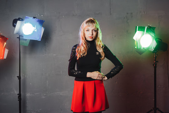 Girl in the room with colored spotlights