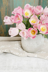Bouquet of pink tulips in ceramic vase.