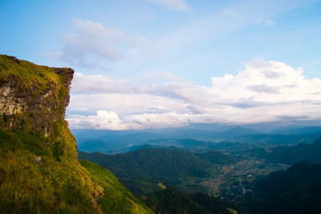 Fototapeta premium Beautiful sunrise scene at high mountain with yellow clouds and blue sky, Phu chi fah Chiangrai Thailand