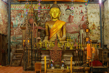 The wooden Buddha statue   in the old buddhist temple 300 year old in the countryside of Thailand.