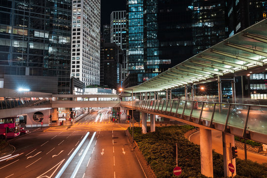 Modern night cityscape, blurred car lights