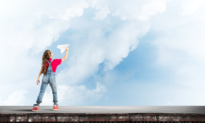 Concept of careless happy childhood with girl dreaming to become pilot