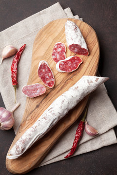 Sliced salami on cutting board