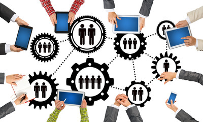 Top view of businesspeople sitting at table and using gadgets