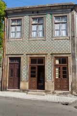 Typical Colorful Portuguese Architecture: Tile Azulejos Facade with Antique Windows And Balcony - Portugal