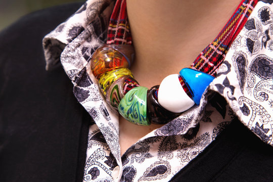 Caucasian woman’s  neck with  colorful necklaces