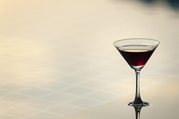 Cocktail glasses at pool with  sunset
