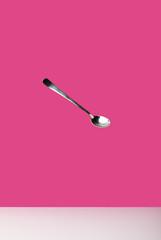 close-up view of single empty spoon isolated on pink