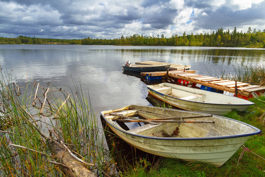 Idyllic lake scenery with boats in cloudy day, Sweden