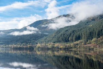 Loch Lubnaig, a part of the Loch Lomond & Trossachs National Park in Scottish Highlands. Reflection of Tree and Mountain on water, in Autumn.