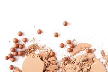 top view of crushed nude cosmetic powder isolated on white