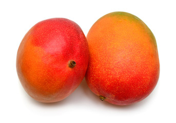 A whole two mango closeup isolated on white background. Tropical, sweet and juicy fruit. Useful and sports nutrition. Health. Flat lay, top view