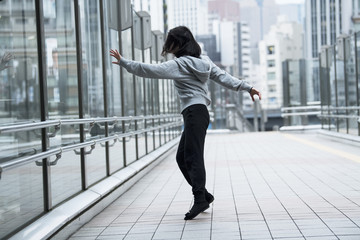 Dancer is practicing the choreography in the city