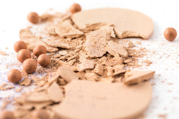 close-up shot of crushed cosmetic powder on white surface