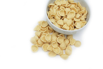 Fresh orecchiette in a bowl. Italian traditional pasta isolated on white background
