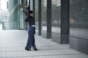 A woman is checking a form of dancing toward the wall