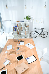 view of empty office interior with table and bicycle against wall