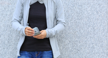 closeup of female hands counting money on city