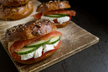 Bagels with cream cheese and smoked salmon on a black background