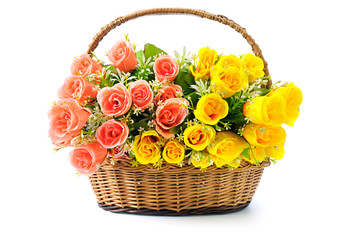 Fototapeta na wymiar Silk red and yellow roses in a basket isolated on white background.