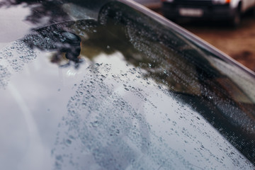 Raindrops on the car glass.
