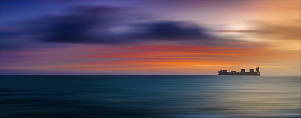 Freight ship at sunset © Nazario