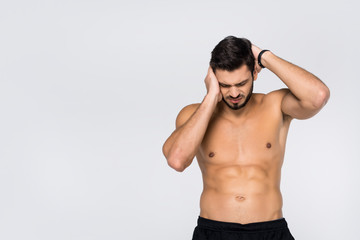 Fototapeta premium shirtless young athletic man with headache isolated on white