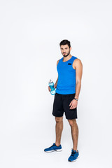Obraz premium athletic young man with fitness bottle isolated on white