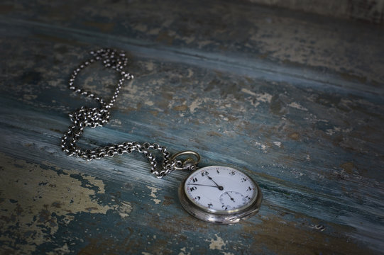 Old pocket watch showing five to twelve