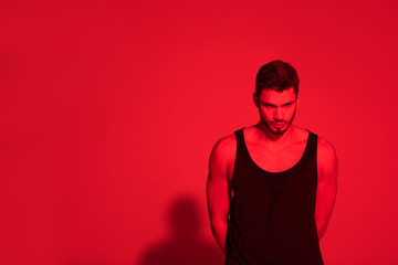 angry young man under contrast red light