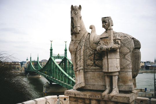 Hungary, Budapest, Stone sculpture of Saint Stephen and Liberty bridge