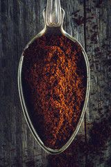 Scoop of Ground Coffee on a wooden background