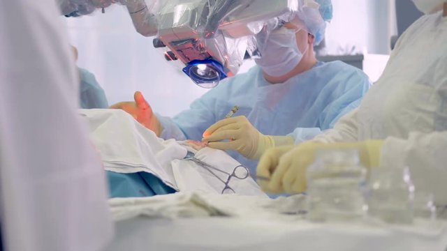 A nurse prepares surgery tools during the operation. 