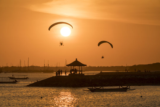 Indonesia, Bali, paragliders during sunset over the beach in Sanur