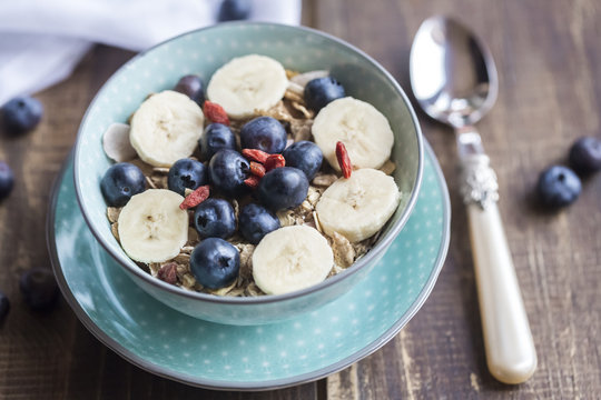 Bowl of blueberry muesli with wolfberries and banana slices