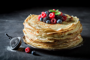 Big stack of pancakes with blueberries and raspberries - obrazy, fototapety, plakaty